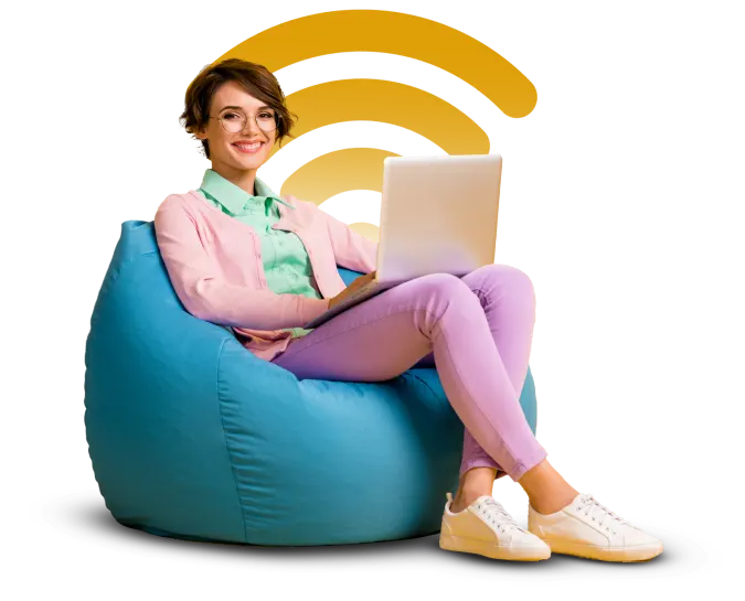 a girl sitting on a couch and using laptop